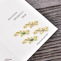 Gold lizard pendant with opal inlay and dual rings on a dark wooden background - Jewelry Connectors / Blue Opal / Gold Gecko