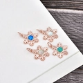 Rose gold snowflake pendants with colorful opal inlays on a dark wood background - Rose Gold Pentagram-Blue Opal
