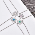 Macro detail of snowflake pendant necklace with colorful opal stones in silver setting - Platinum Snowflake Adjustable Bracelet / Blue