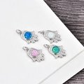 Detailed view of Hamsa Hand pendants with colorful opal stones and zircon pavé - Platinum Hamsa-Blue Opal