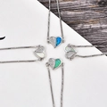 Detailed close-up of heart-shaped opal and zircon charms in four colors on silver box chains - Platinum Heart Blue Opal Bracelet