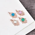 Detailed close-up of rose gold Hamsa Hand pendants with colorful opal stone inlays - Rose Gold Hamsa-Blue Opal