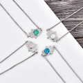Detailed view of Hamsa Hand bracelets with opal insets and sparkling zircon borders - Box Chain Bracelet (Blue Opal) / Platinum Plated Bracelet