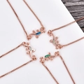 Detailed view of rose gold lizard necklaces featuring vibrant inlaid opal stones - Blue Opal / Rose Gold Gecko Bracelet