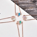 Detail view of heart pendants with colorful opals and pavé cubic zirconia in rose gold - Rose Gold Heart Blue Opal Bracelet