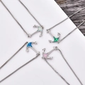 Macro shot of anchor pendants with colorful opals and silver plated box chains - Anchor Bracelet-Blue Opal / White Gold