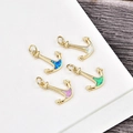 Macro view of gold plated anchor pendants with vibrant inlay opals and jump rings - Gold Anchor-Blue Opal