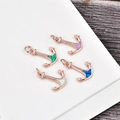 Macro detail of anchor pendants in rose gold with colorful opal inlays and secure rings - Rose Gold Anchor-Blue Opal