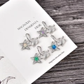 Detailed macro view of turtle pendants with opal hearts and sparkling zircon accents - Blue Opal / White Gold Star with Turtle