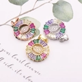 Detailed shot of round pendants with colorful trapezoid zircon and marquise center stones - Eye Zirconia Style / Gold