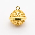 Close-up of golden hollow filigree ball pendant with intricate floral patterns for DIY jewelry - Hollow Sphere Pendant / Gold