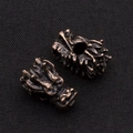Macro detail of retro bronze dragon head beads with intricate carving for DIY jewelry - Antique Red Copper