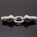Detailed macro view of vintage silver snake head connectors and spring ring jewelry clasp - Antique Silver Snake
