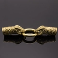 Macro shot of vintage dragon head jewelry connectors with scale texture in antique gold - Antique Gold Snake