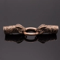 Close-up of vintage dragon head jewelry clasps with detailed scales and bronze finish - Antique Rose Gold Snake