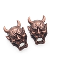 Macro detail of vintage bronze Hannya mask charms for DIY jewelry and paracord beads - Antique Red Copper