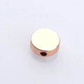Detailed macro view of a rose gold circular spacer bead with smooth central drill hole - 4mm / Rose Gold
