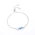 Adjustable silver seahorse bracelet featuring blue opal inlay and sparkling white zircons - White Gold Blue Double Seahorse Artificial Opal