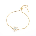 Adjustable gold sun bracelet featuring a central opal stone and sparkling zircon accents - Gold Tone White Sun/Starfish Opal