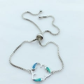 Adjustable silver dolphin bracelet featuring blue opal inlay and a secure box chain slider - Blue Opal Platinum Plated