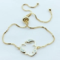 Detail of adjustable golden box chain bracelet featuring three opal-inlaid dolphins - White Opal Gold Plated