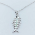 Detailed view of a gold-plated fishbone pendant featuring iridescent opal inlay details - Platinum / White (With Chain)