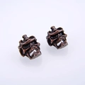 Detailed macro view of vintage zinc alloy skull beads with antique finish for DIY jewelry - Antique Red Copper