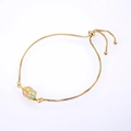 Macro detail of leaf-shaped bracelet charm with opal inlay and micro-pave crystals - Gold Chain White Synthetic Opal