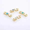 Close-up of gold LOVE connectors with opal hearts and zircons for DIY jewelry making - Gold Multicolor
