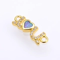 Macro shot of gold-plated heart opal connector with pavé zircon for DIY jewelry making - Gold Pink