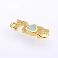 Macro view of gold MOM connector with heart opal and pavé zircons for jewelry making - Golden White