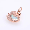 Macro view of swan pendant in rose gold with white crystals and iridescent opal inlay - Rose Gold White Opal