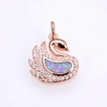 Macro detail of rose gold swan pendant featuring vibrant opal inlay and micro-pave zircons - Rose Gold Pink Opal