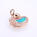 Detail of rose gold swan pendant featuring a vibrant blue opal and pavé crystals - Rose Gold Green Opal