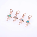 Detail of four rose gold flamingo pendants with iridescent opal inlay and top rings - Rose Gold Opal Pendant Mixed Colors