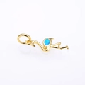 Close-up of golden flamingo pendant with oval blue opal stone inlay and polished finish - Gold Blue Opal Pendant