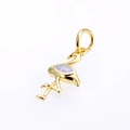 Macro shot of a gold flamingo pendant with a pink opal stone and polished metal finish - Gold Pink Opal Pendant