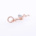 Macro shot of rose gold flamingo pendant featuring colorful opal inlay and polished metal - Rose Gold Pink Opal Pendant