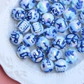 DIY mixed blue and white acrylic beads with embossed heart and text patterns in a ceramic tray - Blue and White Porcelain Style Mix
