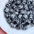 Macro shot of assorted black and white acrylic beads with cute cat and flower patterns - Mixed Black Bead with White Cream Pattern