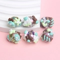 Macro detail of six acrylic hand-painted beads with 3D floral patterns for DIY jewelry - Transparent Bead with Green Brown Cream Pattern