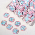 Macro detail of acrylic poker chip beads in pastel pink and blue for DIY jewelry crafts - Pink