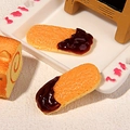 Miniature finger biscuits with chocolate coating on a floral tray for dollhouse decor - Chocolate Finger Biscuit
