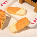 Macro detail of miniature resin cookies and swiss rolls with realistic cream texture - Cream Finger Biscuit