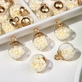 Close-up of glass orb pendants filled with imitation pearls and gold metal caps - Light Yellow