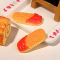 Close-up of miniature resin ladyfinger biscuits with red jam detail for DIY crafts - Strawberry Jam Finger Biscuit