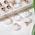 Detailed view of round glass globe pendants with white beads and gold metal caps - White