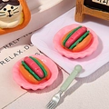 Macro shot of miniature hot dog models with tiny pink trays for DIY resin crafts - Pink Plate Hot Dog