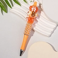 DIY beaded pen with orange base and elegant faux pearl design and dessert charms - Sweet Orange