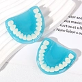 Macro shot of blue resin tooth charms with milky white faux teeth for DIY keychains - Sky Blue